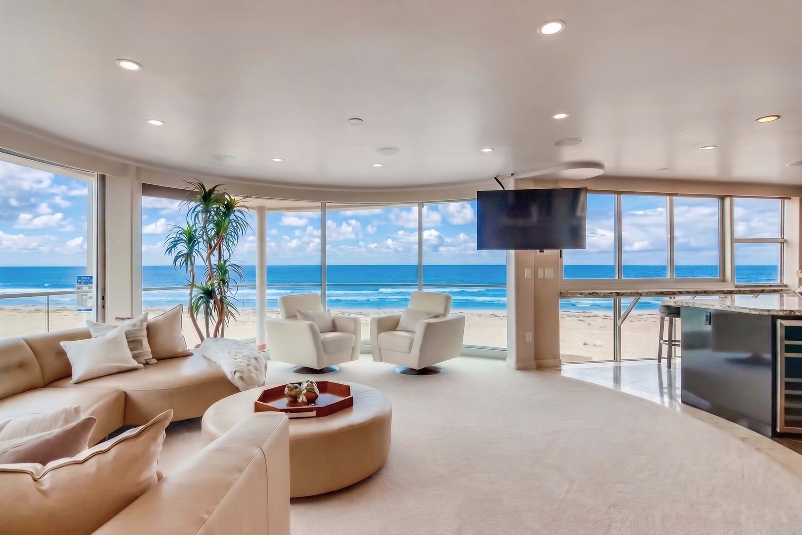 Sink into plush seating and let the panoramic ocean views wash over you—your private beachfront retreat where relaxation meets luxury.