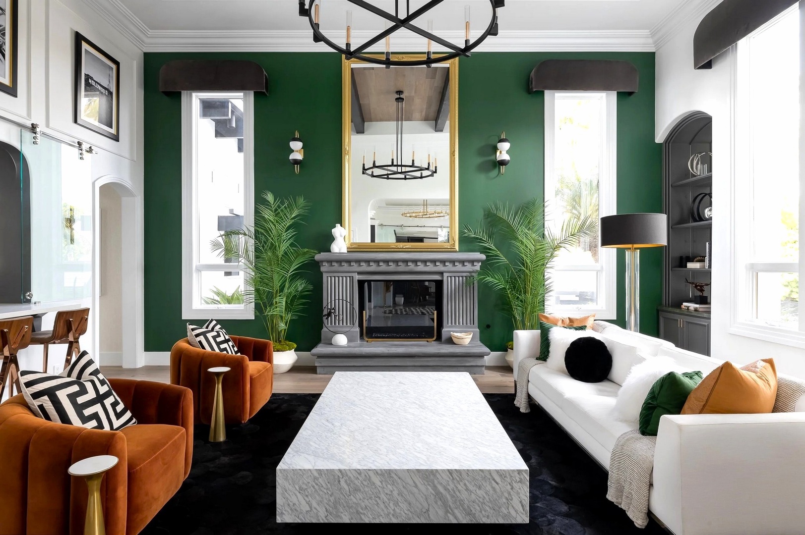 Settle into this stunning living room where emerald walls and luxurious furnishings create your perfect retreat for relaxation.