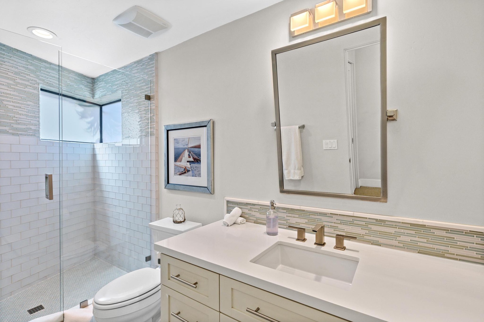 Step into your private spa-like retreat with sparkling subway tile, a spacious walk-in shower, and elegant fixtures designed for your comfort and relaxation.