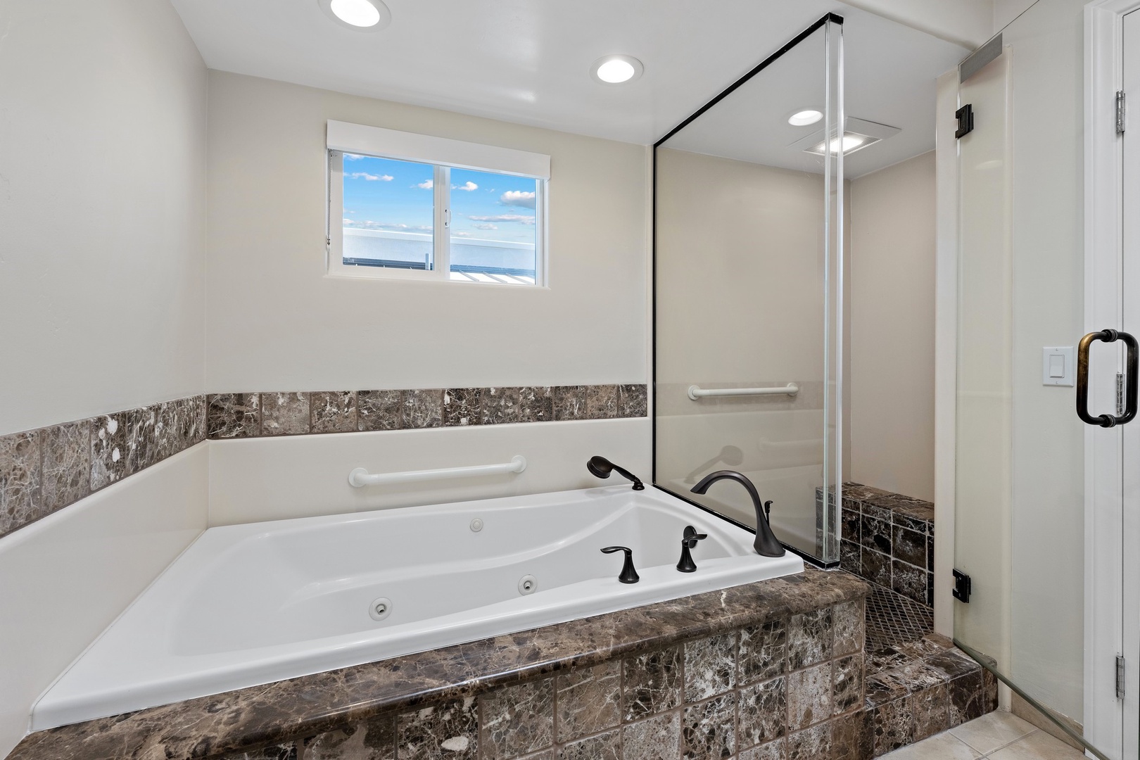 En suite bath with tub and shower