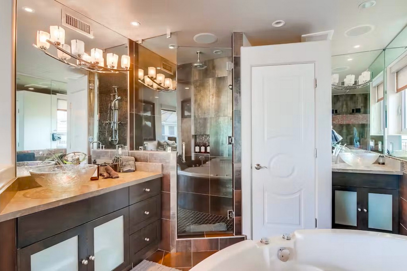 Your private spa-like retreat awaits with a soaking tub, walk-in shower with rainfall head, dual vanities, and warm ambient lighting—designed for ultimate relaxation after a day of adventure.