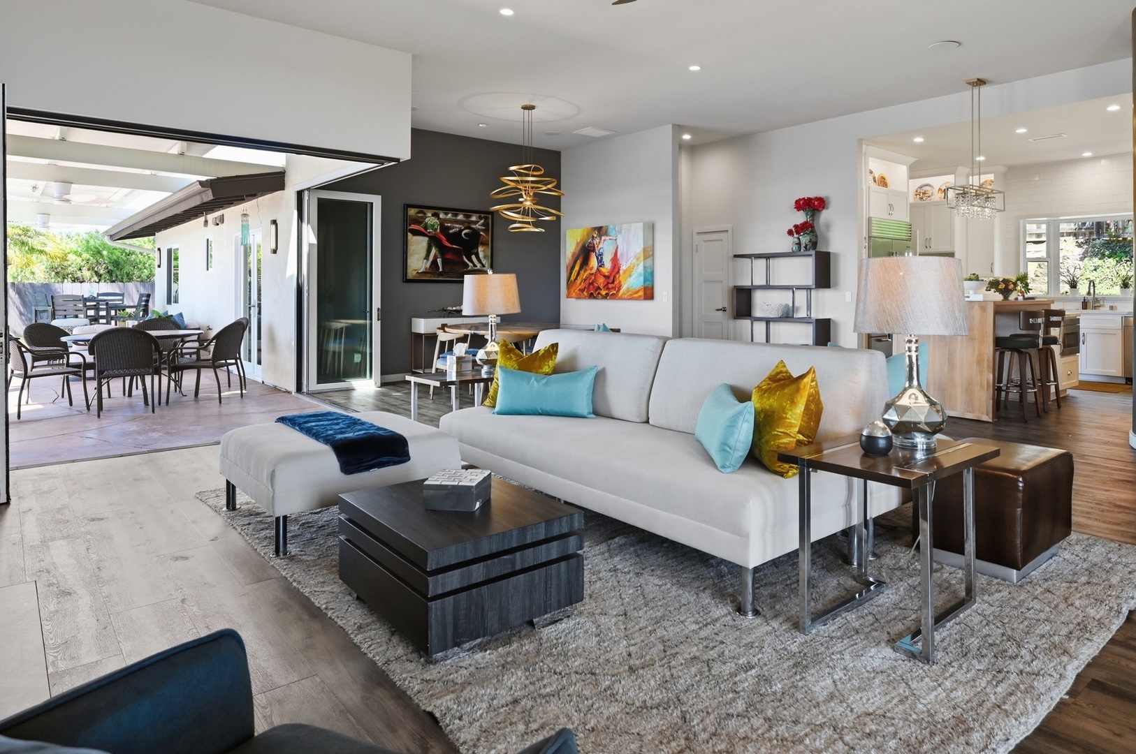 Sink into this stylish living space where modern comfort meets vibrant design, with your patio retreat just steps away.