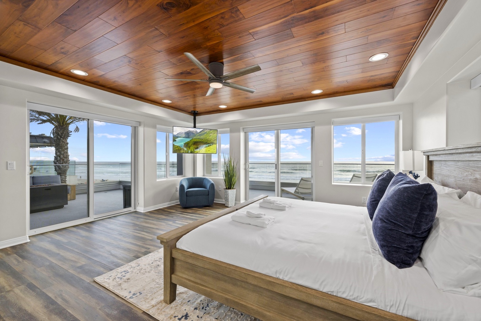 King bed with TV and ceiling fan