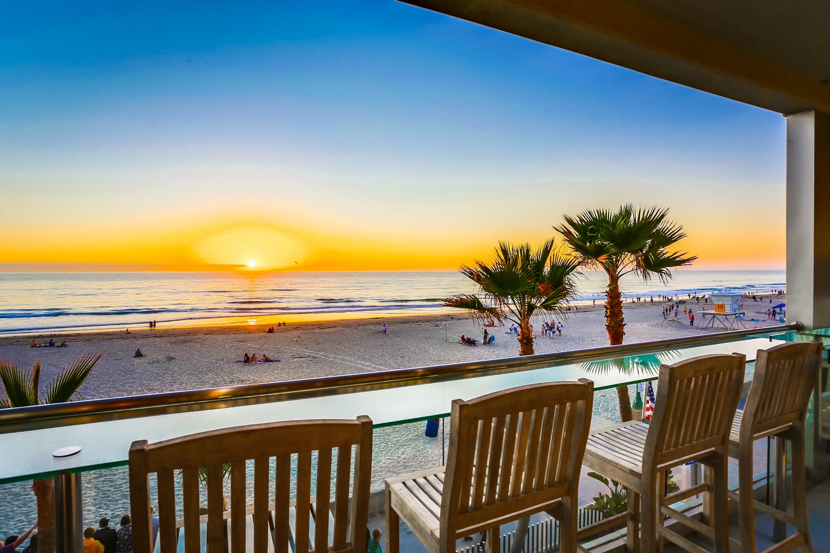 Watch the sun dip into the ocean from your private balcony