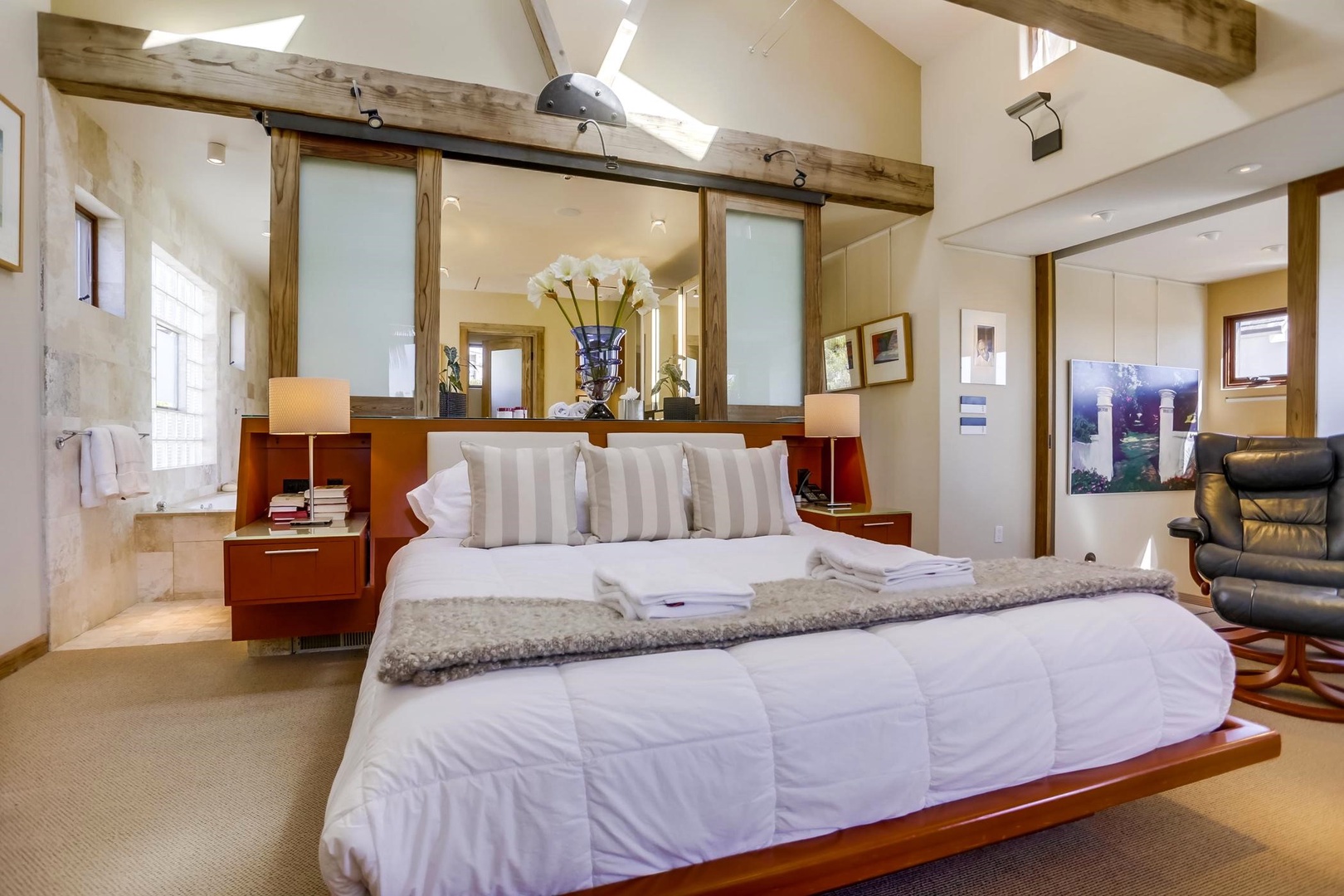 Primary suite with vaulted ceiling & king bed