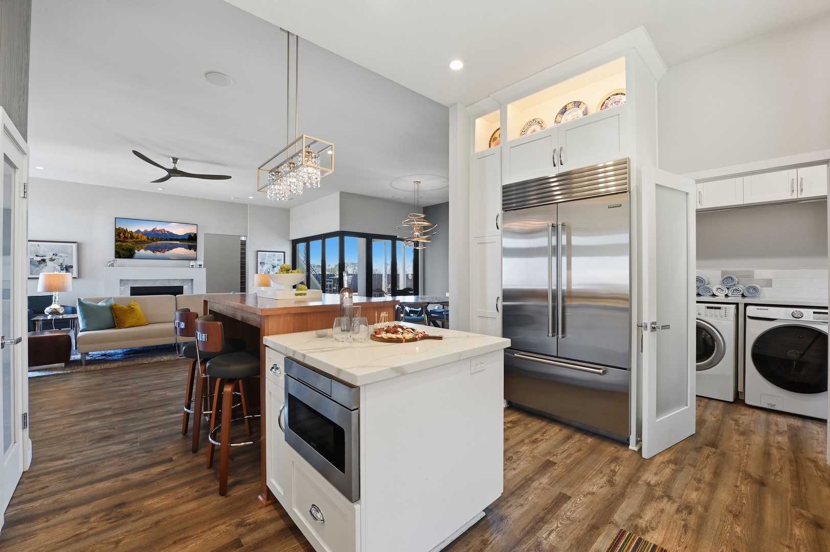 Your gourmet kitchen features sleek appliances, quartz countertops, and flows seamlessly into the elegant living space.