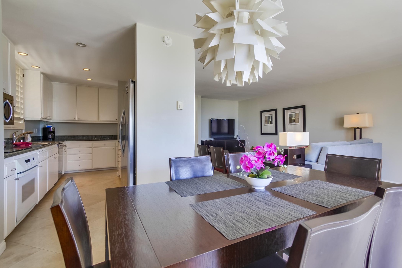 Dining table located between living area and kitchen