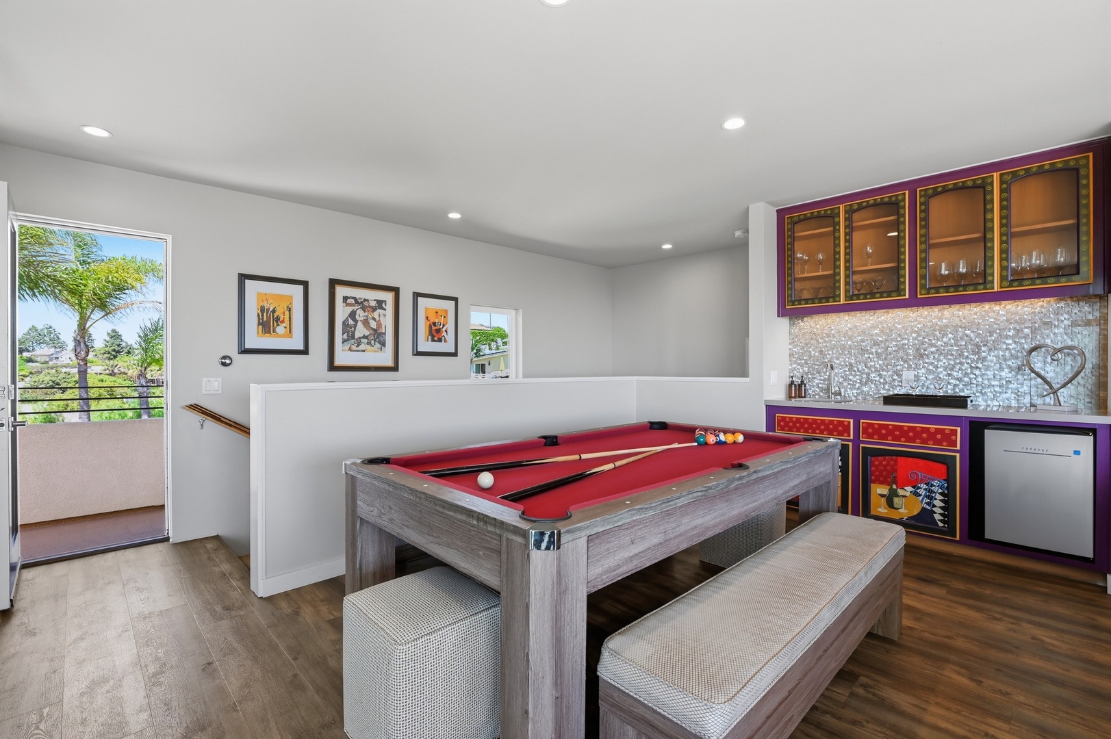Challenge friends to pool in your upstairs game room featuring a sleek red-felt table and wet bar for refreshments.