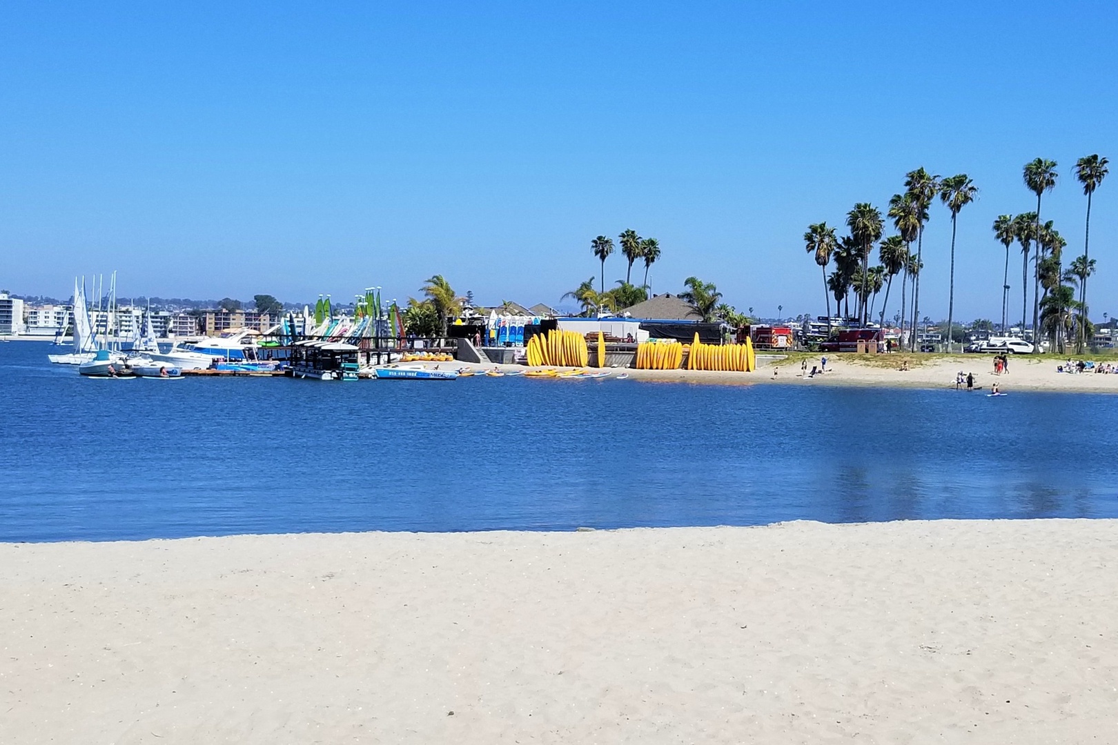 Nearby Mission Bay Aquatic Center over a sandy beach with calm blue waters