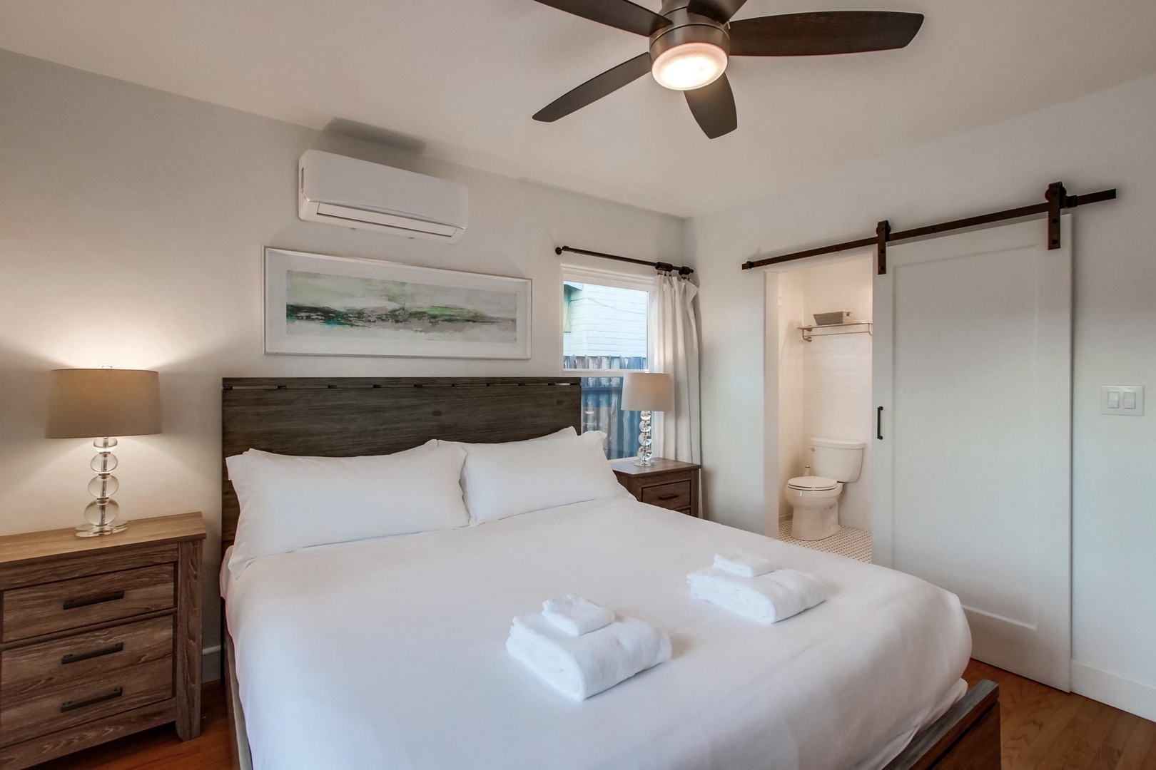 The suite features a TV and ceiling fan