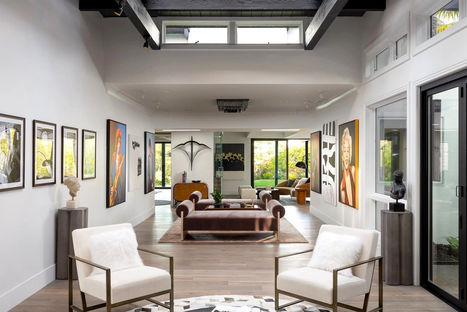 Unwind in this stunning open-concept living space where soaring ceilings and curated art create your sophisticated home away from home.
