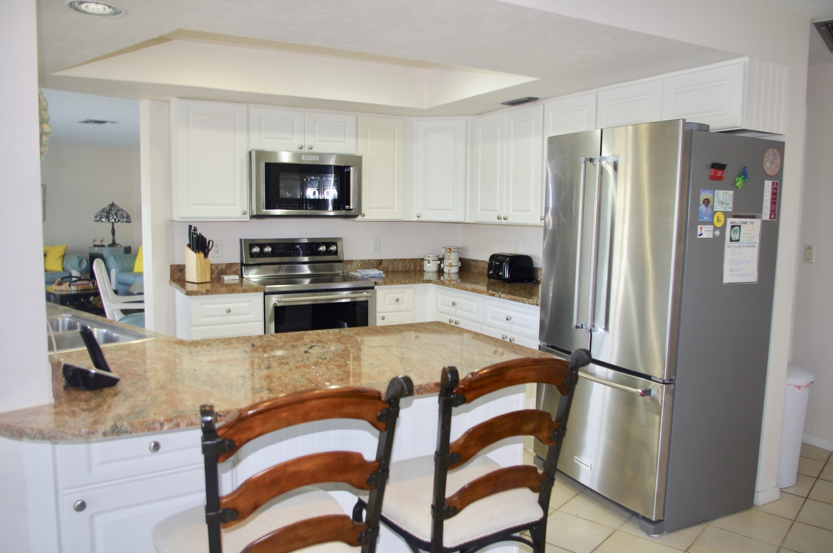 The kitchen features Kitchen-Aid appliances, pool and water view.