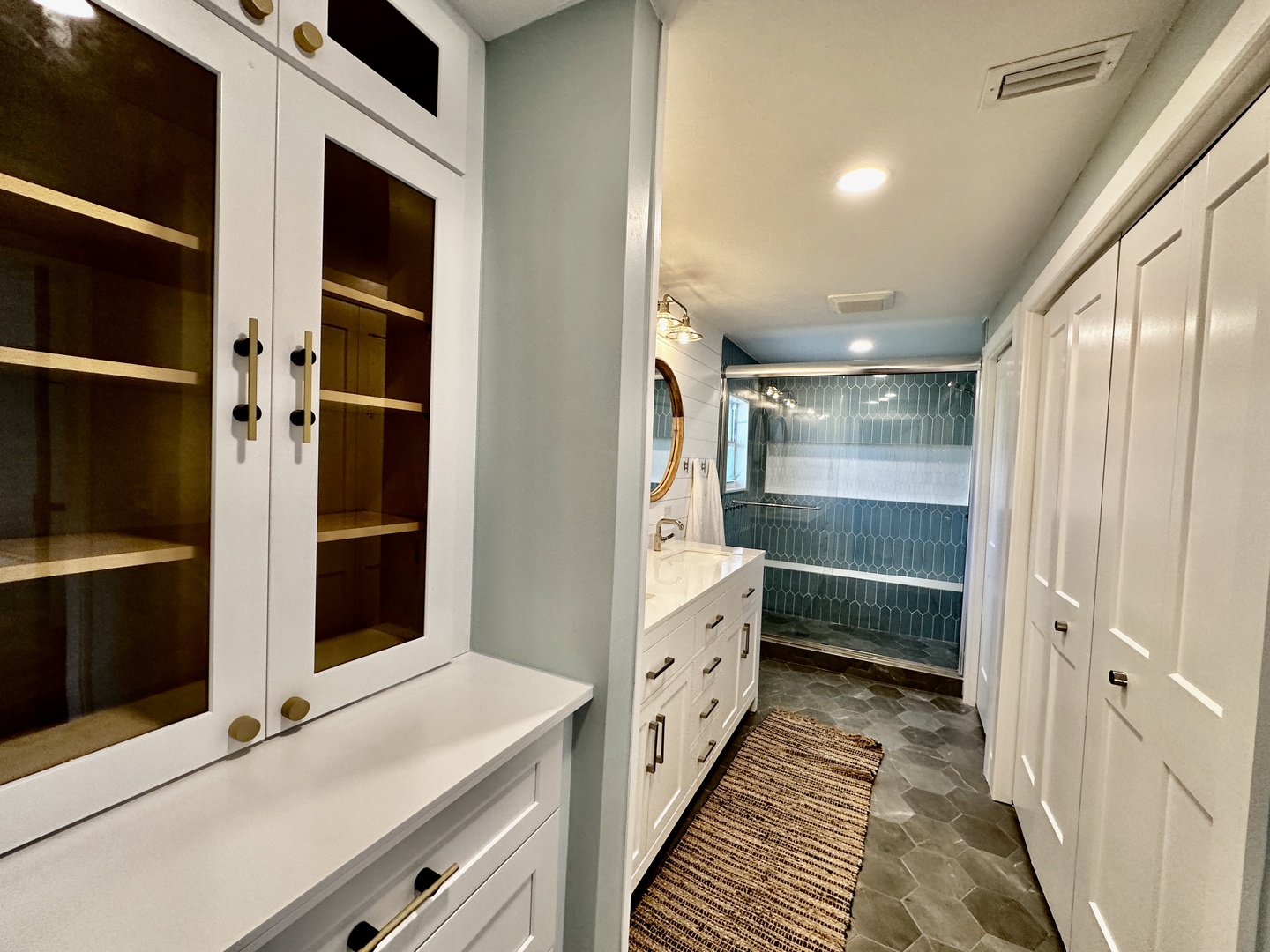 The dressing area has ample built-ins and dual closets.