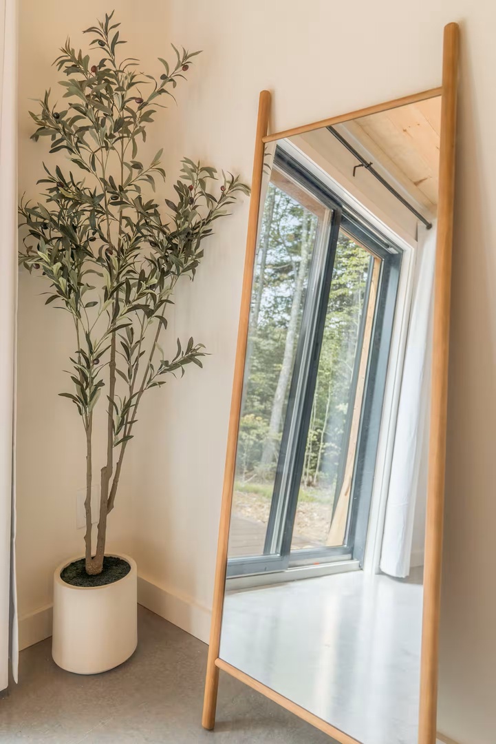 Light fills your space through large windows that frame views of the surrounding forest, creating a serene connection to nature from the comfort of your retreat.