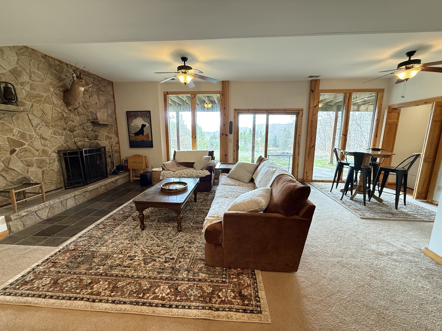 Sink into your cozy living room with stone fireplace and lake views. You'll love the warm wood accents and comfortable seating.