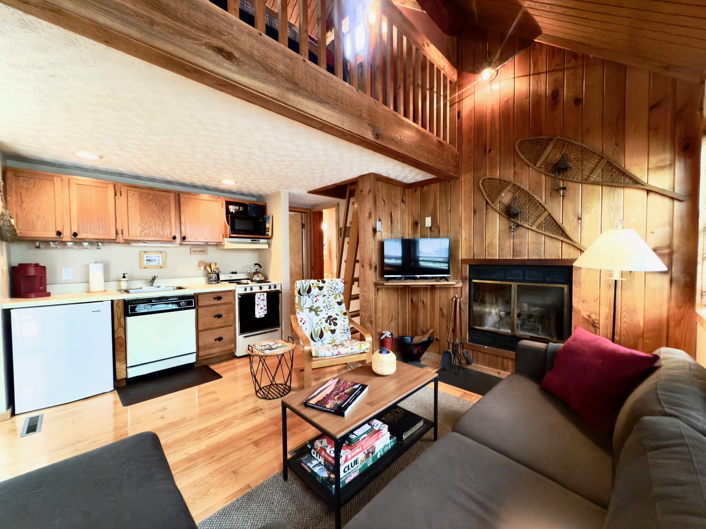 Cozy up in this rustic loft where warm wood surrounds you, the fireplace crackles nearby, and your kitchen awaits your culinary adventures.