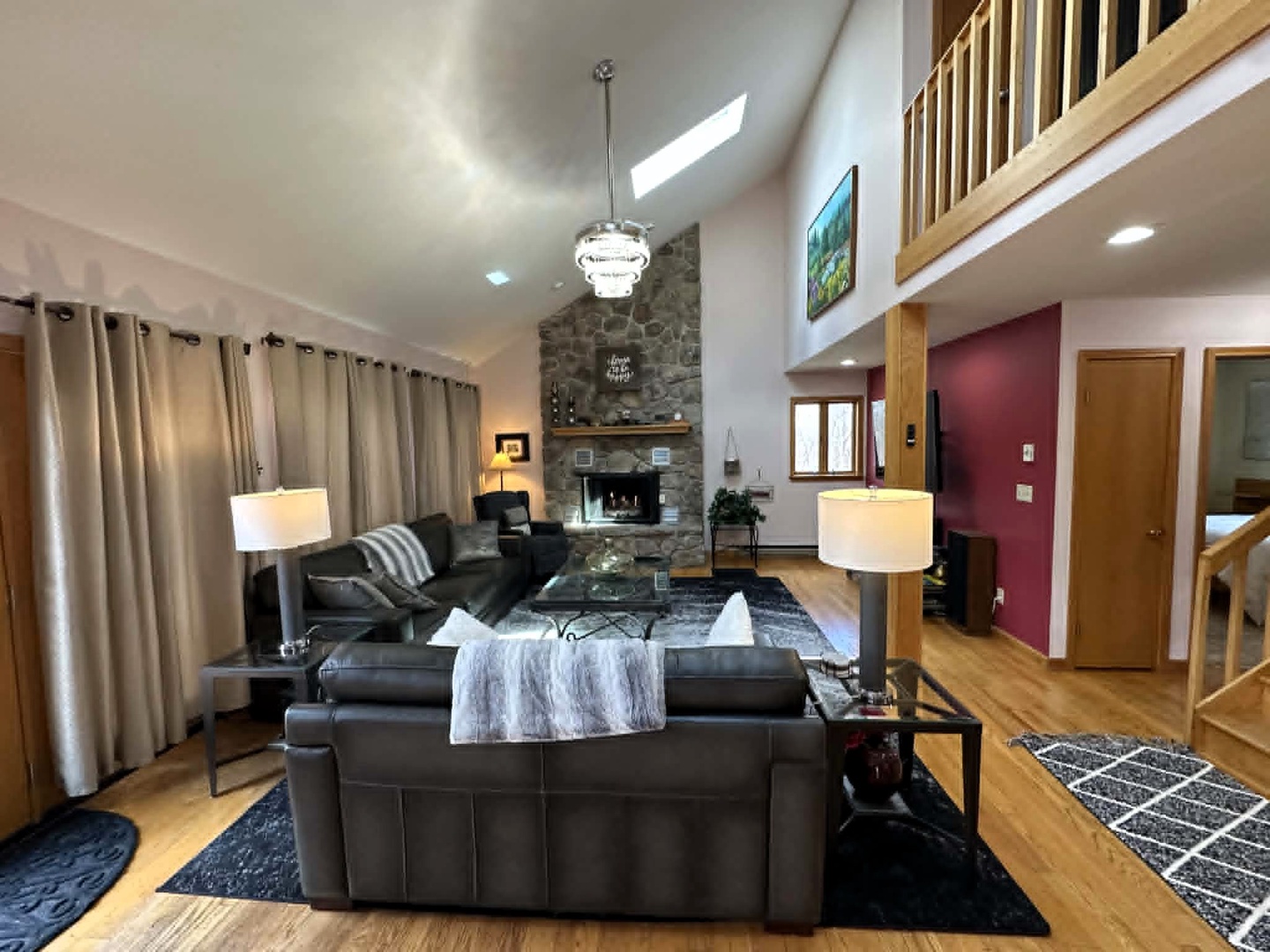 Relax in your spacious living room with soaring ceilings, cozy fireplace, and plush leather seating perfect for unwinding after your adventures.