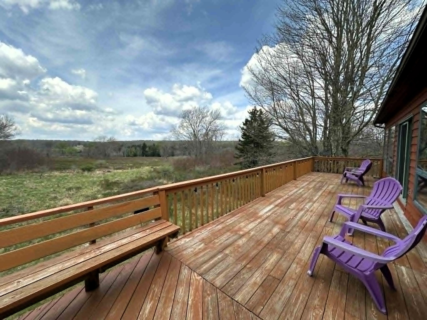 Relax on your private deck with purple Adirondack chairs while soaking in sweeping countryside views.