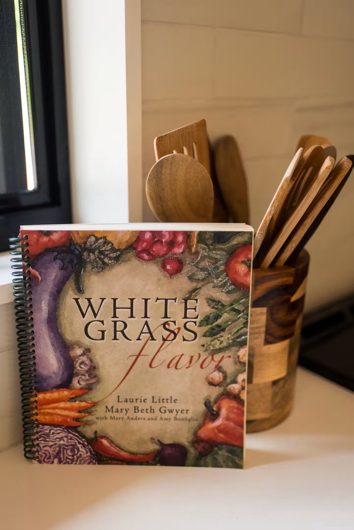 A well-stocked kitchen awaits your culinary adventures, complete with wooden utensils and cookbook to inspire your home-cooked meals during your stay.