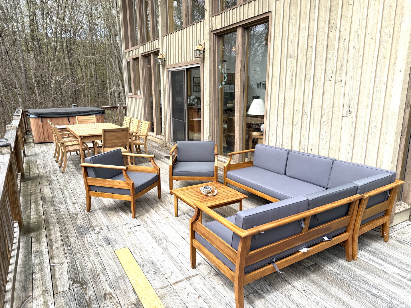 Step onto your private deck and sink into plush outdoor seating, perfect for morning coffee or evening relaxation. With a hot tub nearby and wooded views all around, this is your peaceful retreat.
