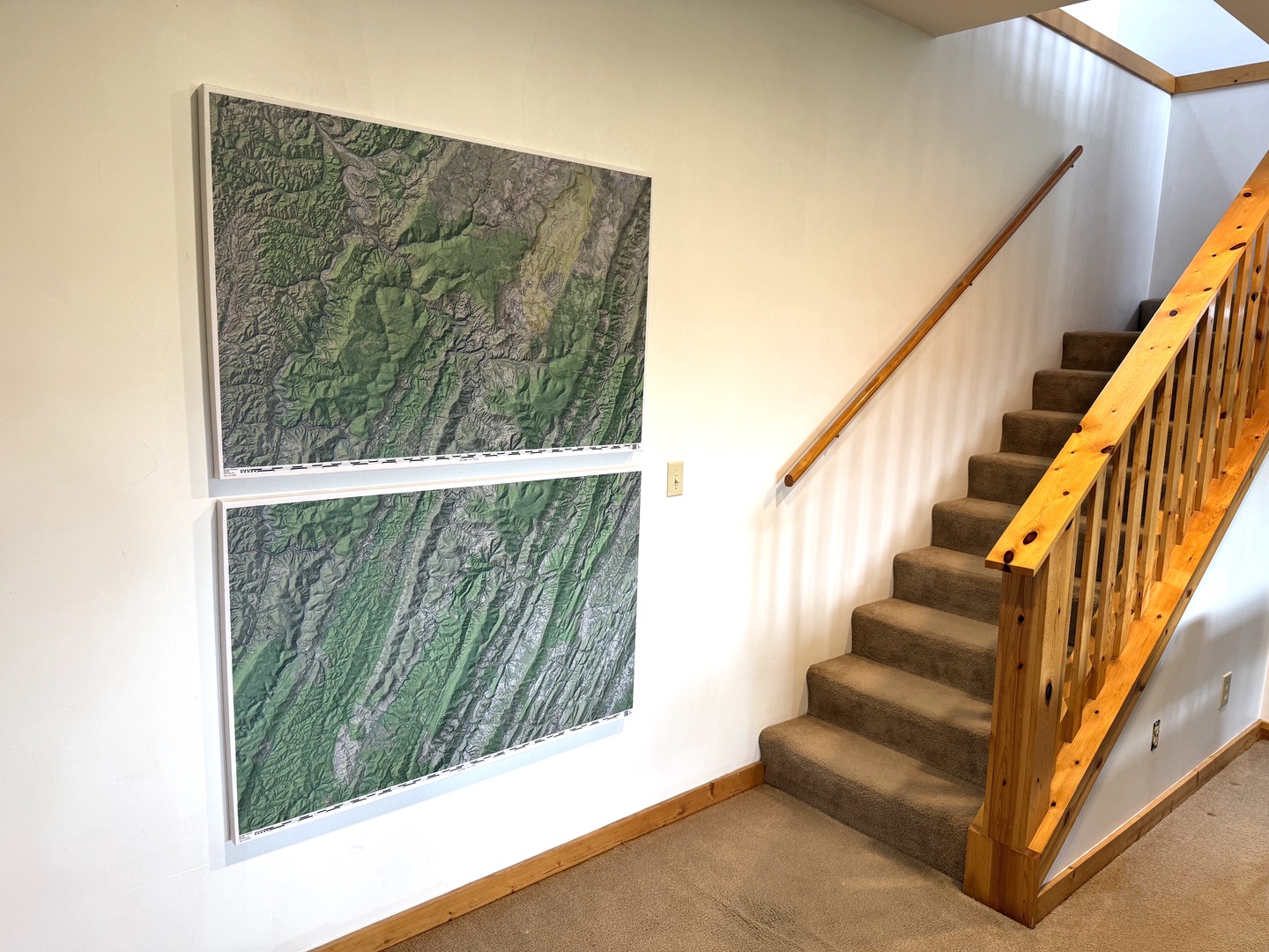 Ascend the staircase beneath a skylight that floods the space with natural light, while topographic maps hint at the adventures awaiting you in the surrounding mountains.