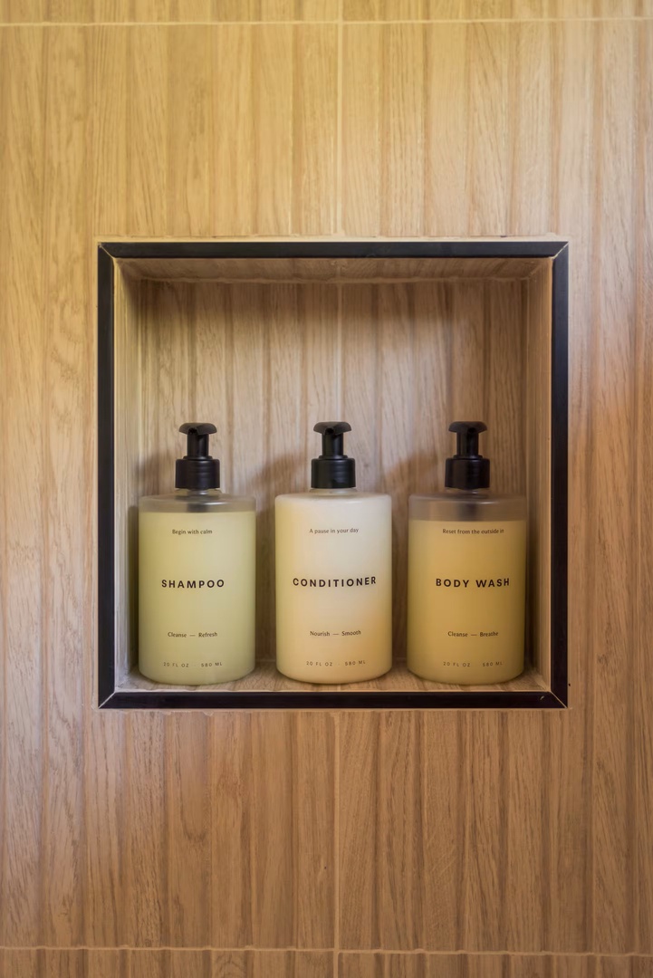Quality bath essentials await in your bathroom, featuring shampoo, conditioner, and body wash for your comfort and care.