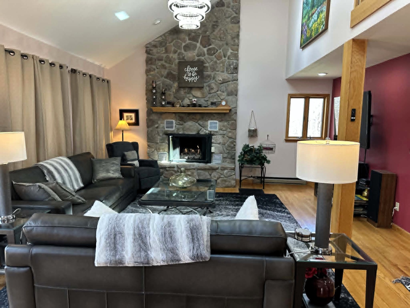 Sink into plush leather seating beside the crackling stone fireplace, where warm lighting and cozy throws create your perfect retreat.