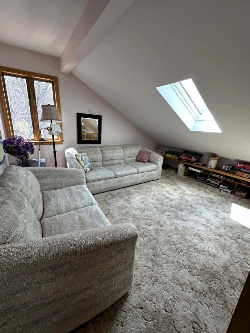 Cozy loft living space where you'll love curling up on plush sofas with natural light streaming through skylights.