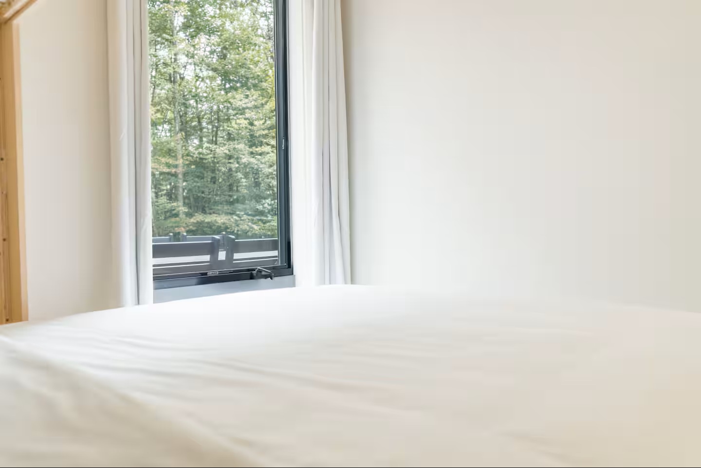 Wake up to lush forest views framing your window, where crisp linens and natural light create your peaceful retreat.
