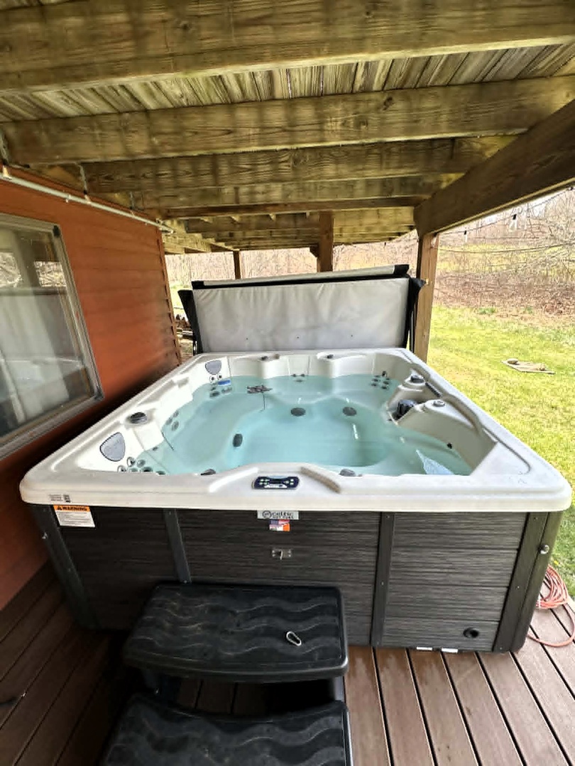 Unwind in your private hot tub, perfectly sheltered under the covered deck where you can soak away stress while enjoying garden views.