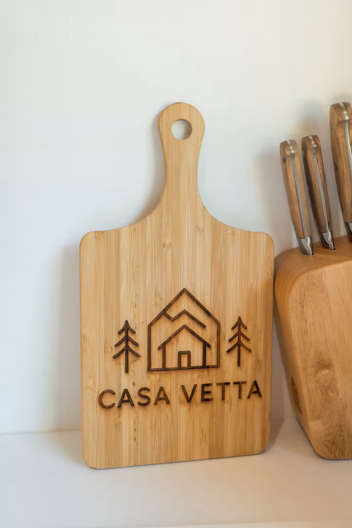 A personalized cutting board with Casa Vetta branding adds a welcoming touch to your fully equipped kitchen.