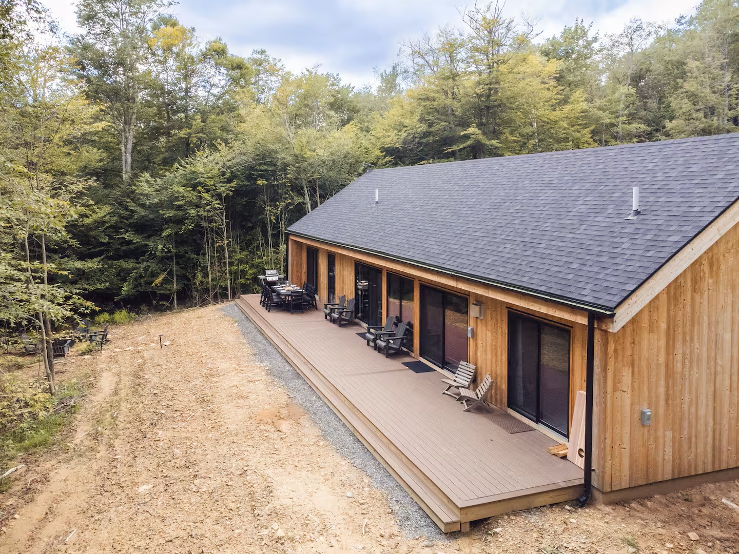 A modern cabin retreat set against lush forest surroundings, offering peaceful seclusion and natural beauty right at your doorstep.