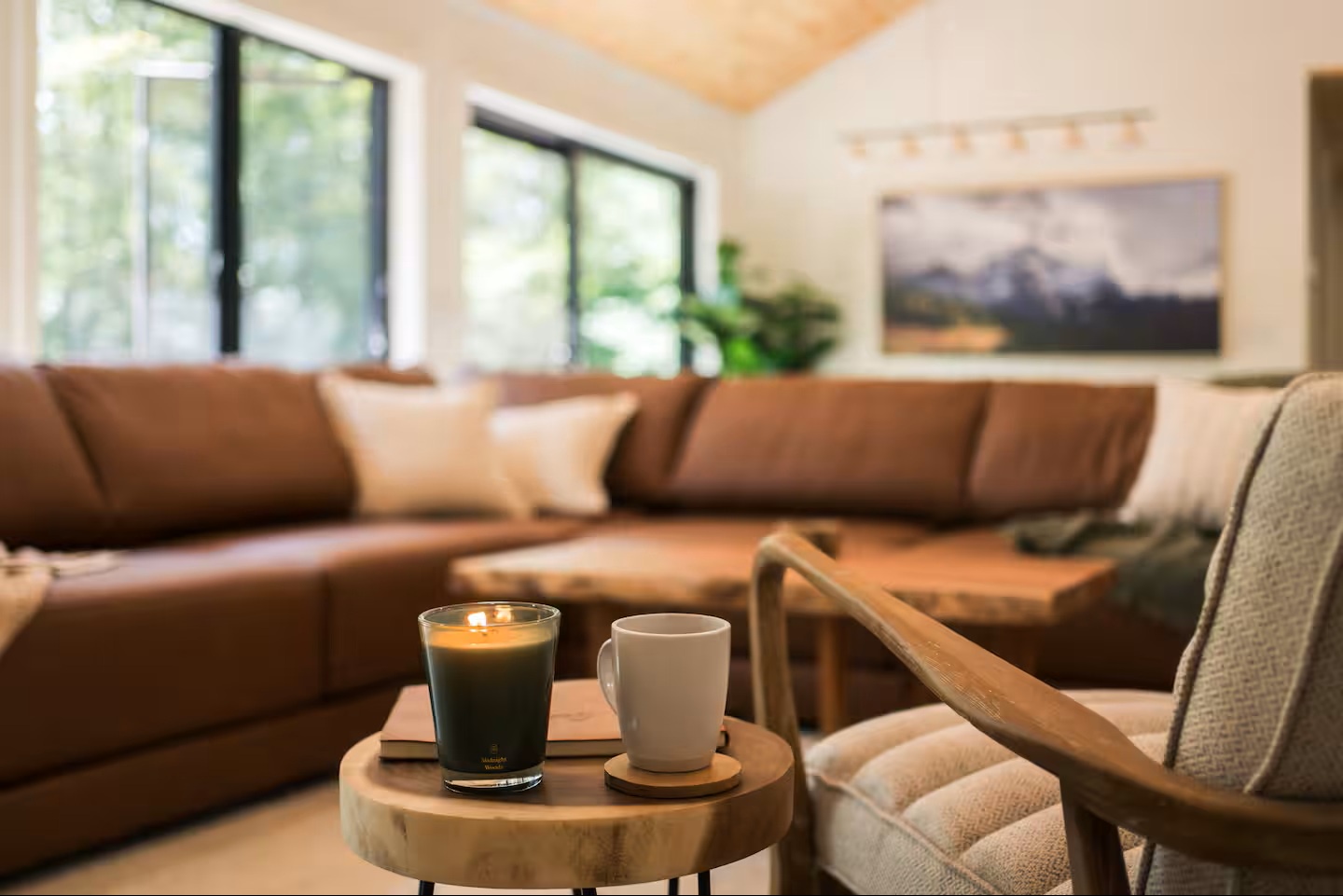 Sink into plush seating in this sun-drenched living room, where natural light streams through large windows and you can unwind with your morning coffee on the inviting sectional.