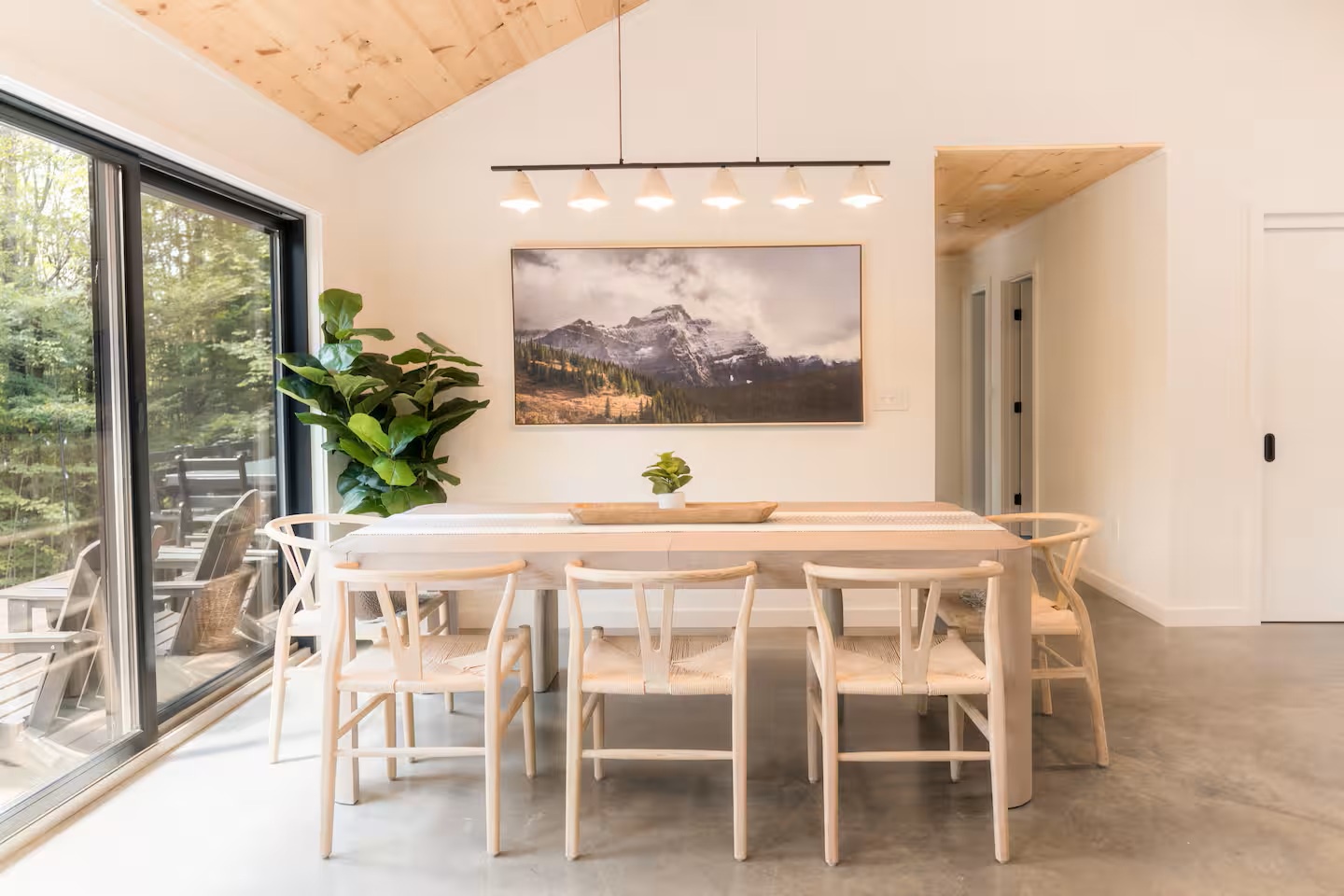 Gather around this beautiful dining table bathed in natural light, perfect for your morning coffee or a leisurely meal with loved ones. The space flows seamlessly to your private outdoor area.