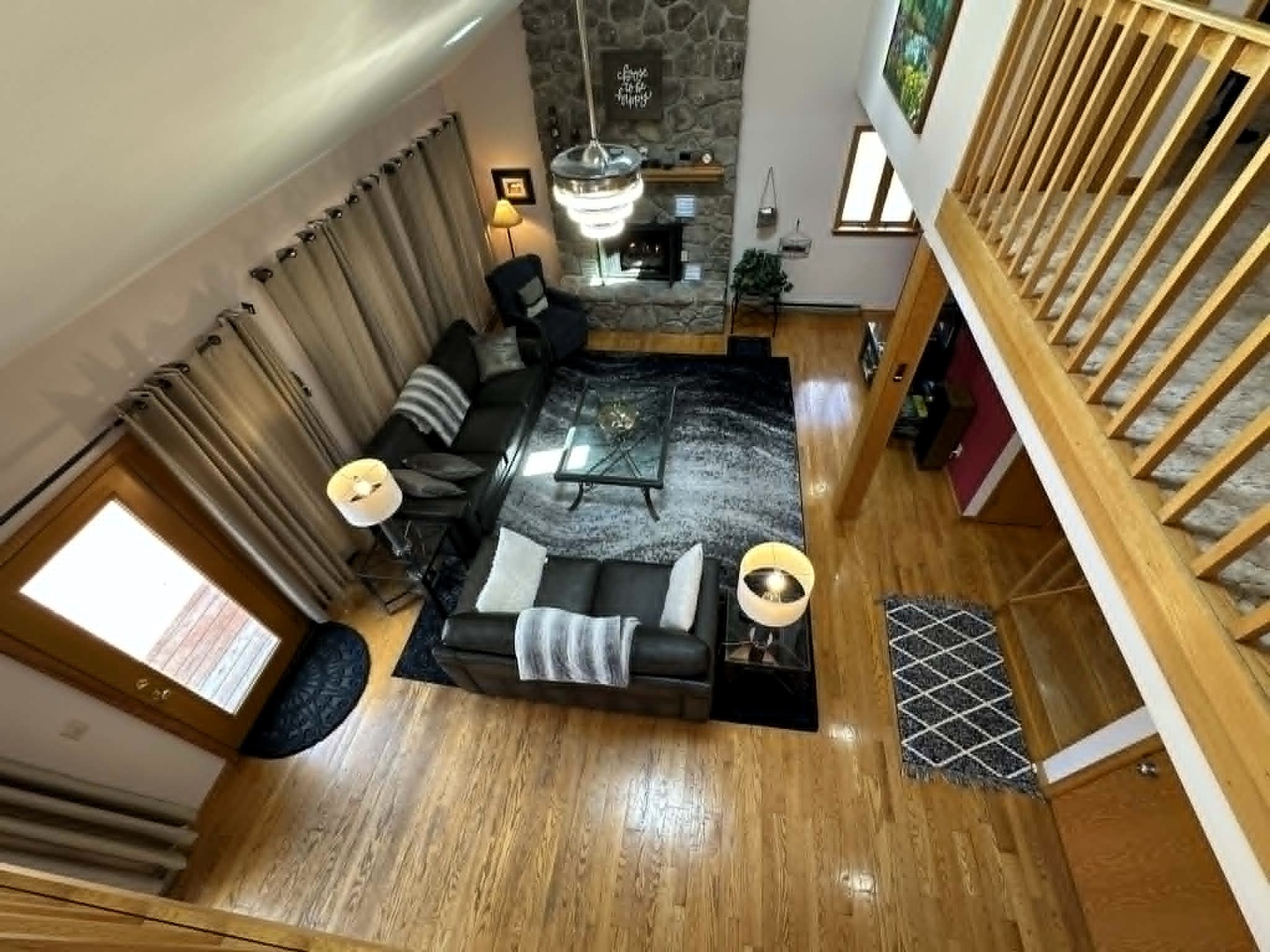 Relax in your stylish living room with plush sofas, warm fireplace, and soaring ceilings that create an open, inviting atmosphere.