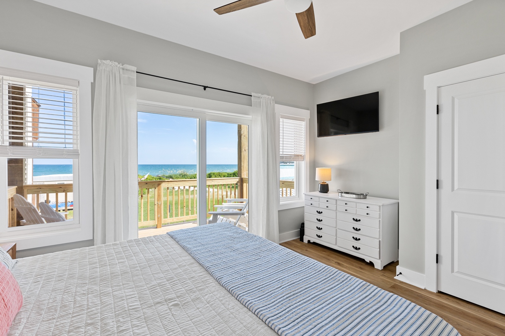 Bedroom 2 with a king-sized bed, Smart TV, and ocean view balcony access