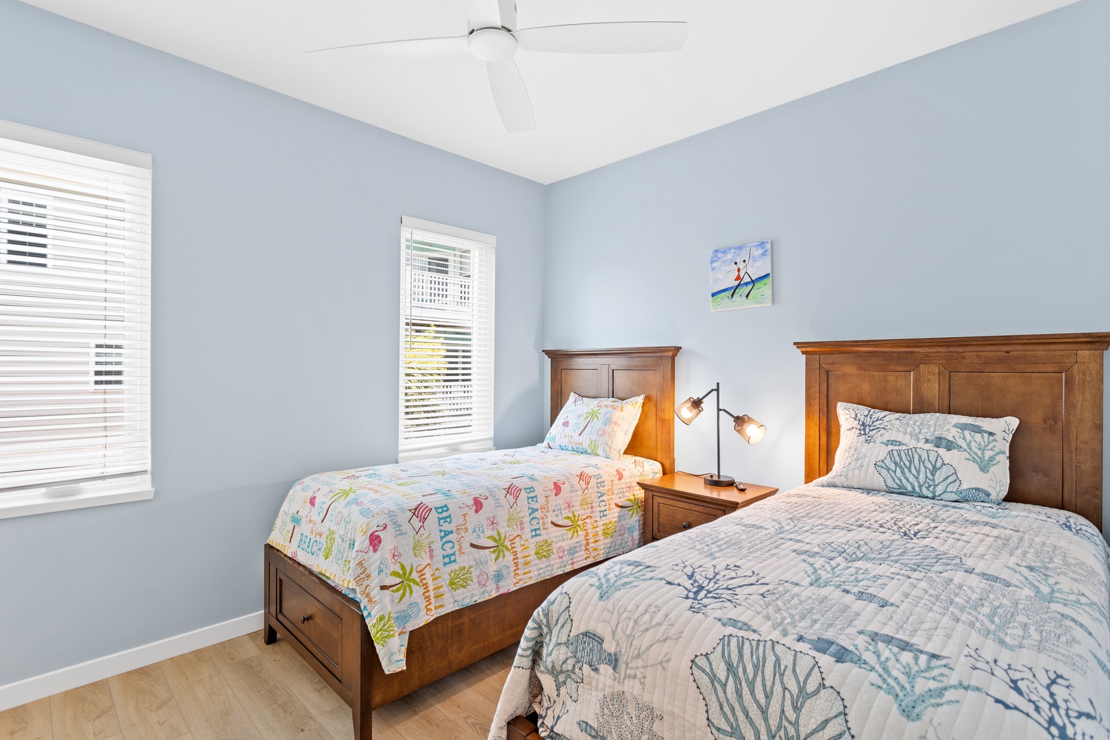 The guest bedroom with two twin-sized beds and a Smart TV