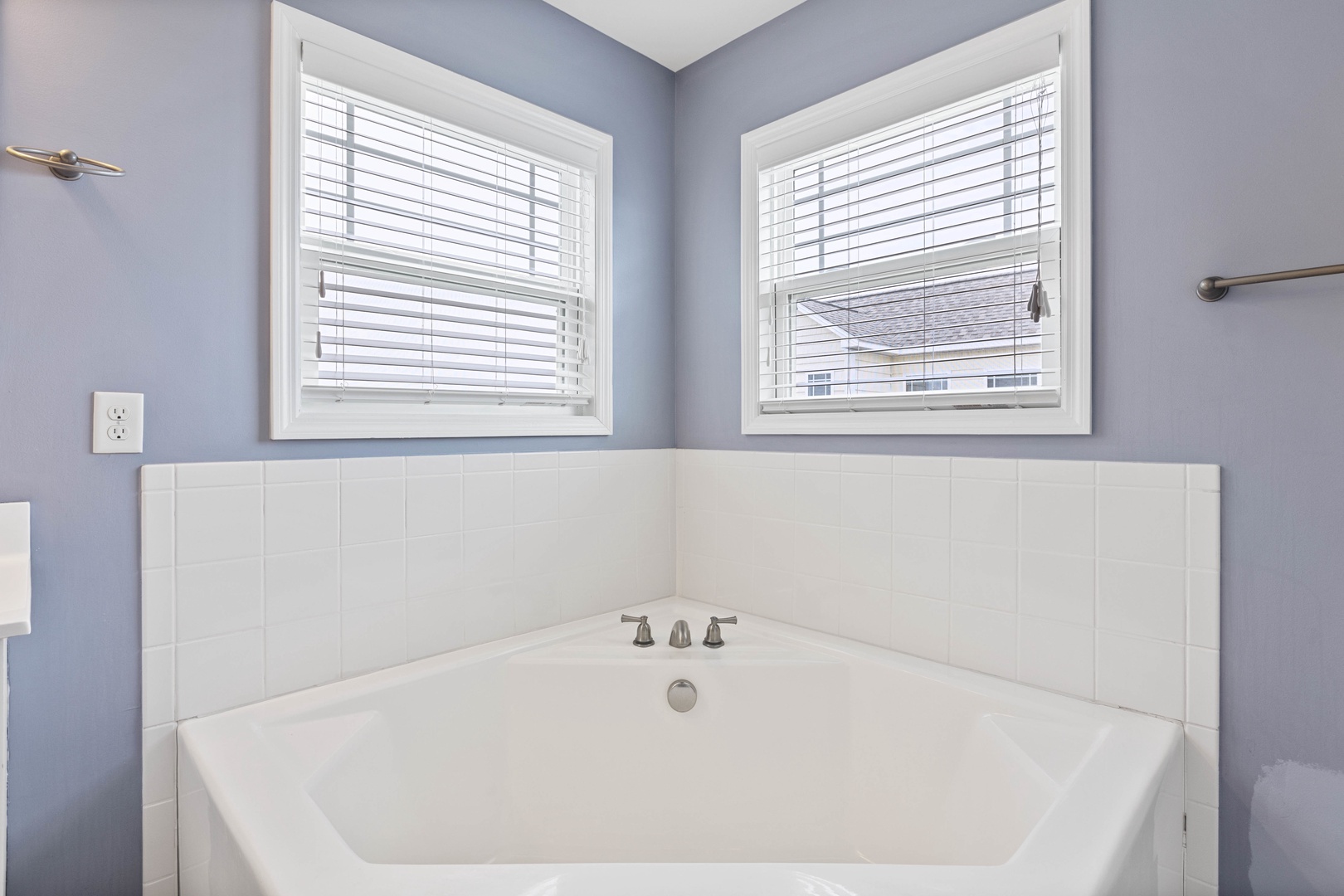 The ensuite bathroom with a walk-in shower, separate tub, and double vanity