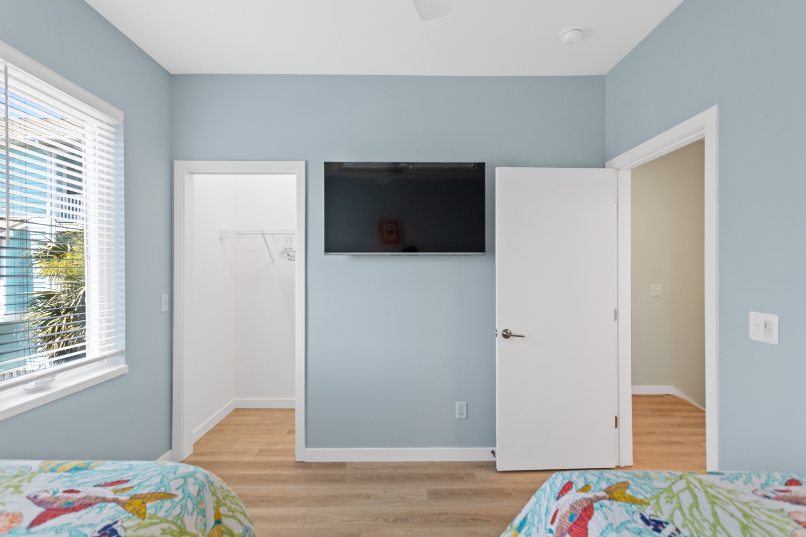 Guest bedroom with two twin beds and a flat-screen TV