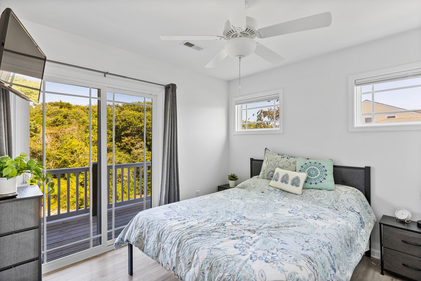 Bedroom 3 offers a queen-sized bed and balcony access