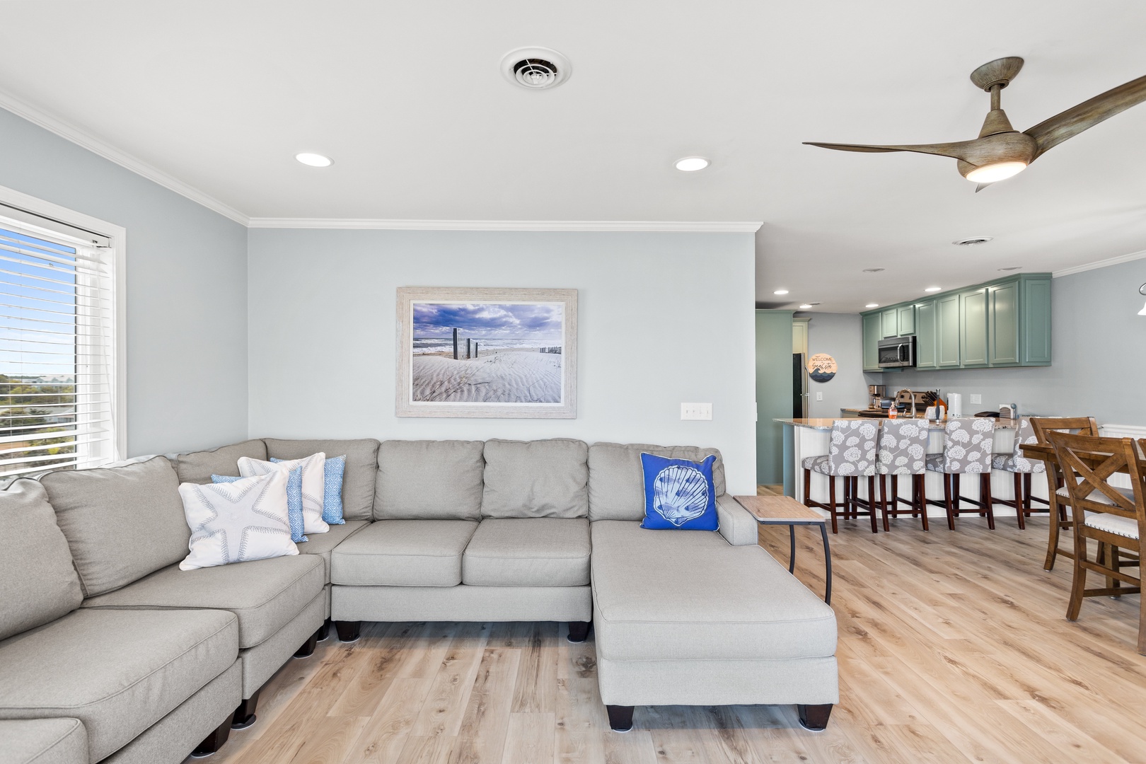 The living area with a Smart TV and balcony access