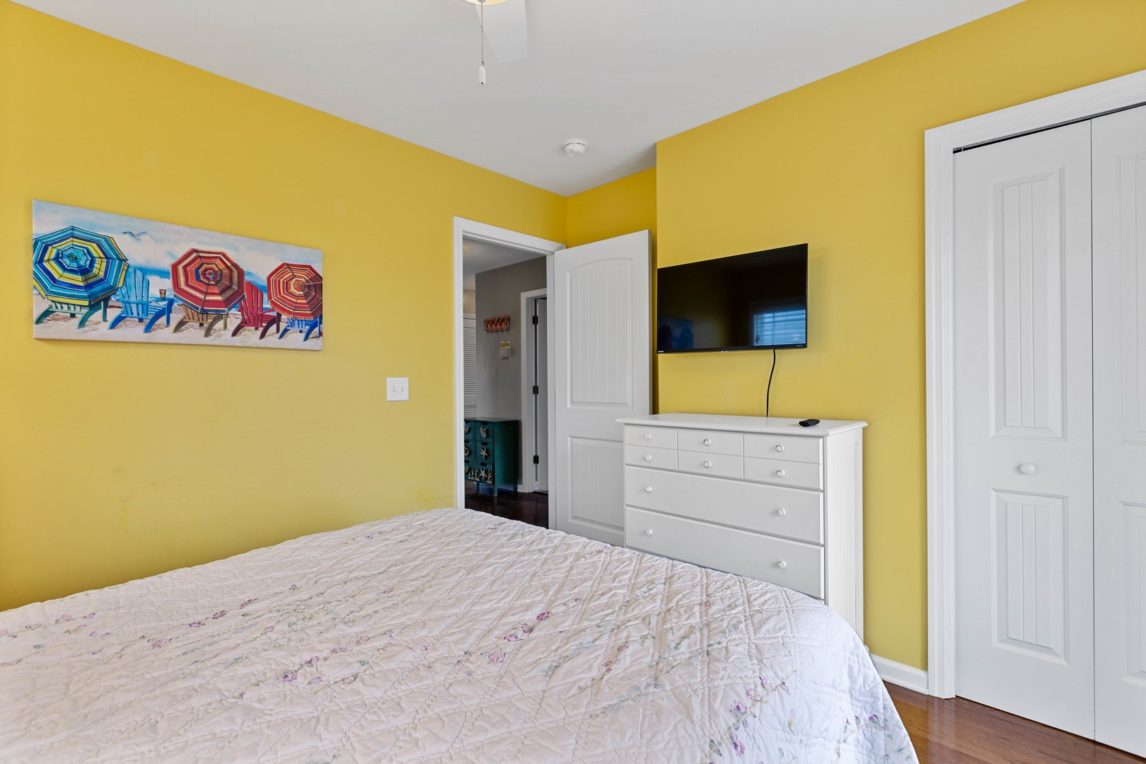 Bedroom 3 with a queen-sized bed, Smart TV, and first floor balcony access