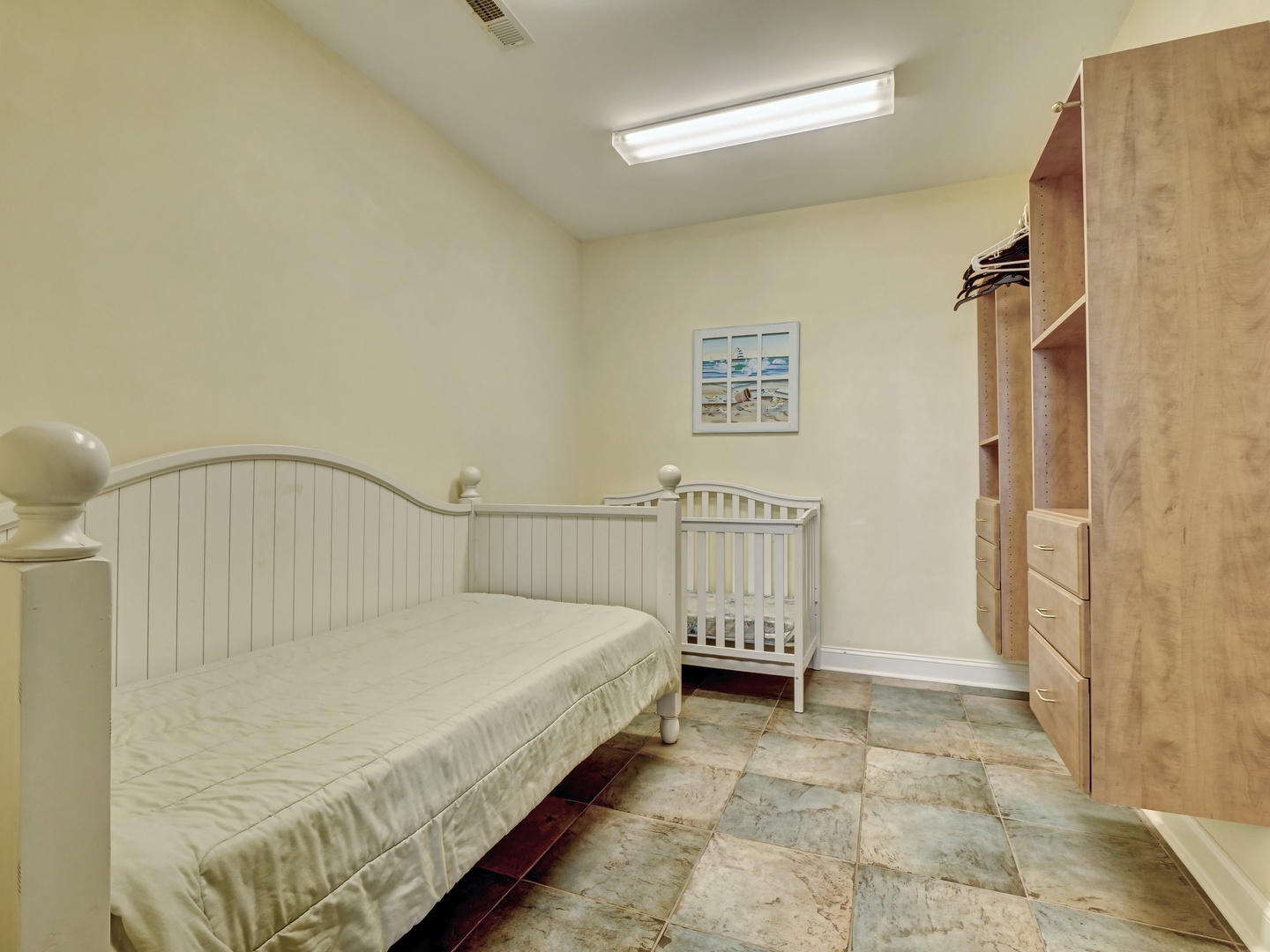 Guest room with a twin-sized bed and crib