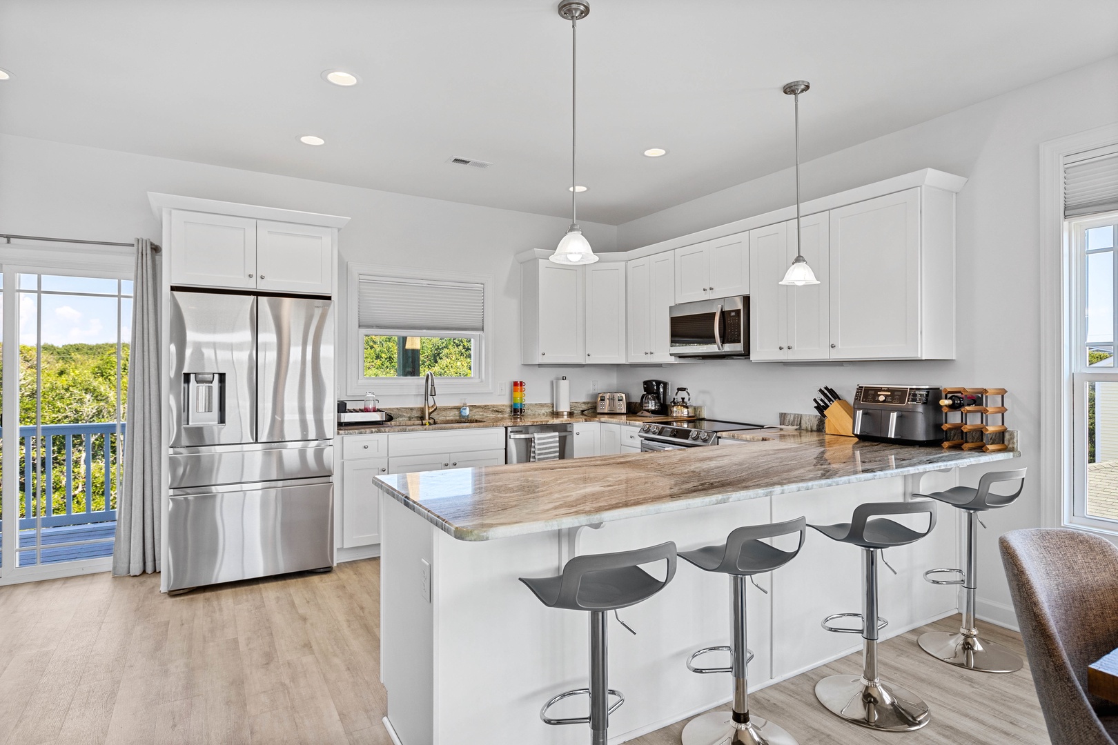 The well-stocked kitchen with stainless appliances and countertop seating
