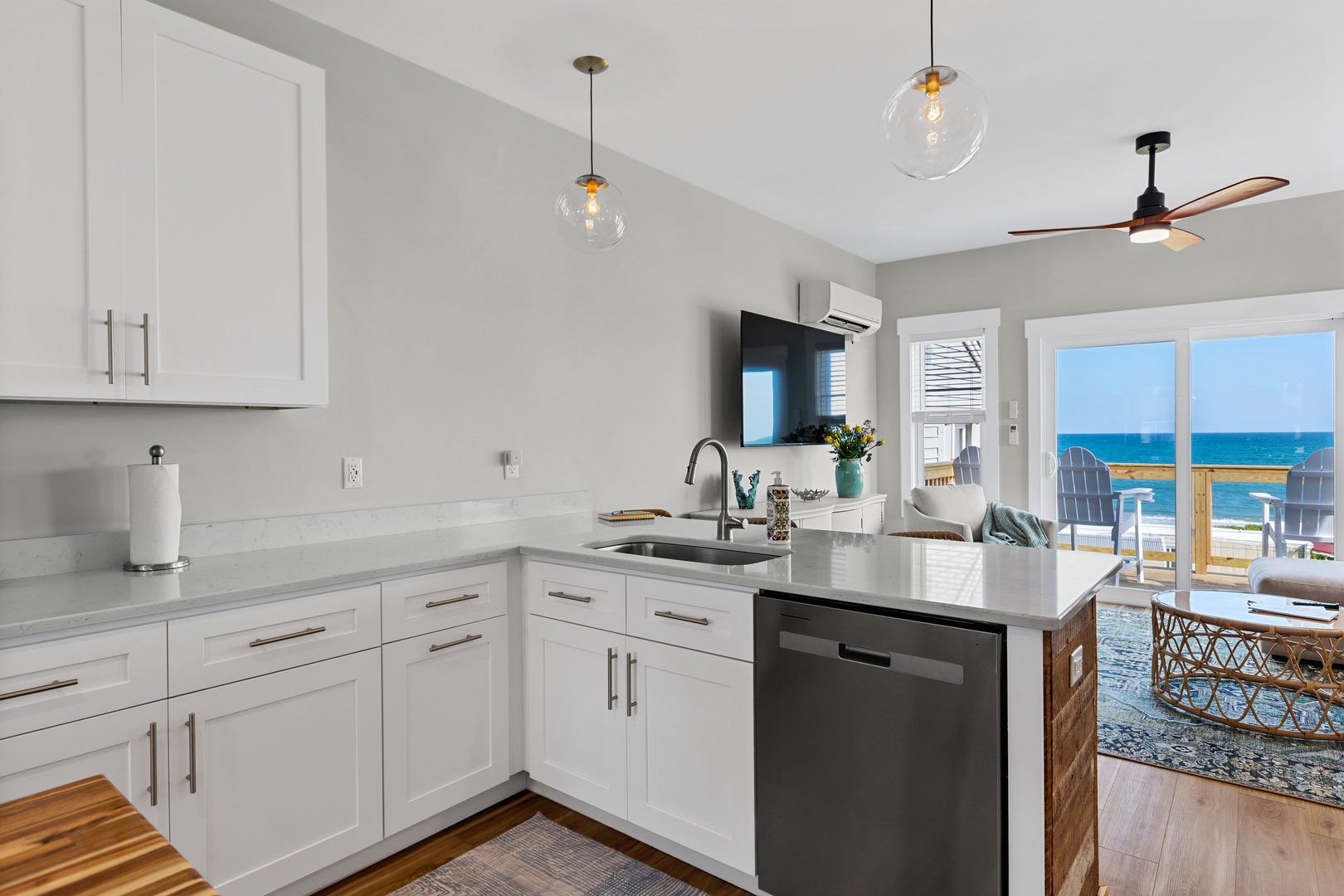 The well-stocked kitchen with countertop seating for 3 and island seating for 2