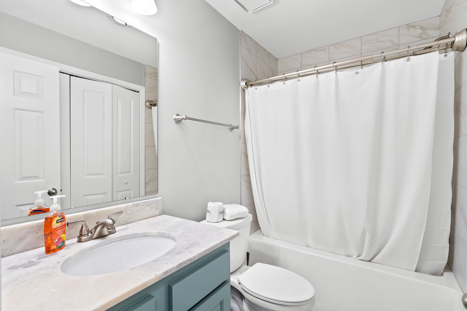 The shared bathroom with a shower-tub combination