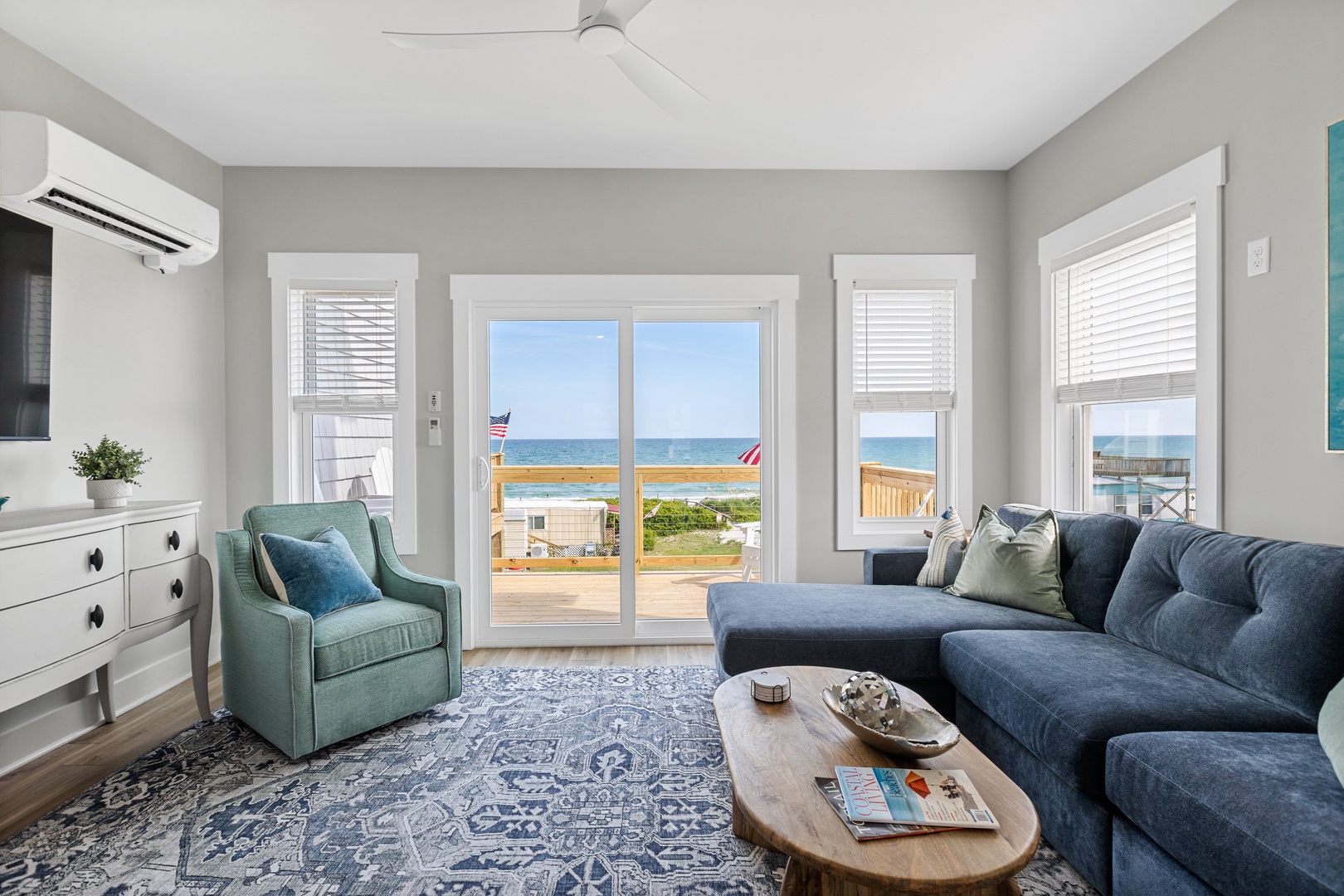 The living area with comfortable seating, a Smart TV, and top-floor balcony access