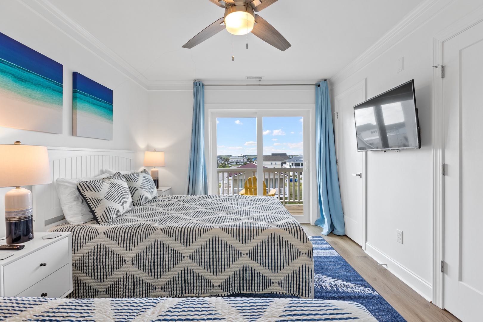 Bedroom 5 with a queen-sized bed, twin bed, Smart TV, ensuite, and balcony access