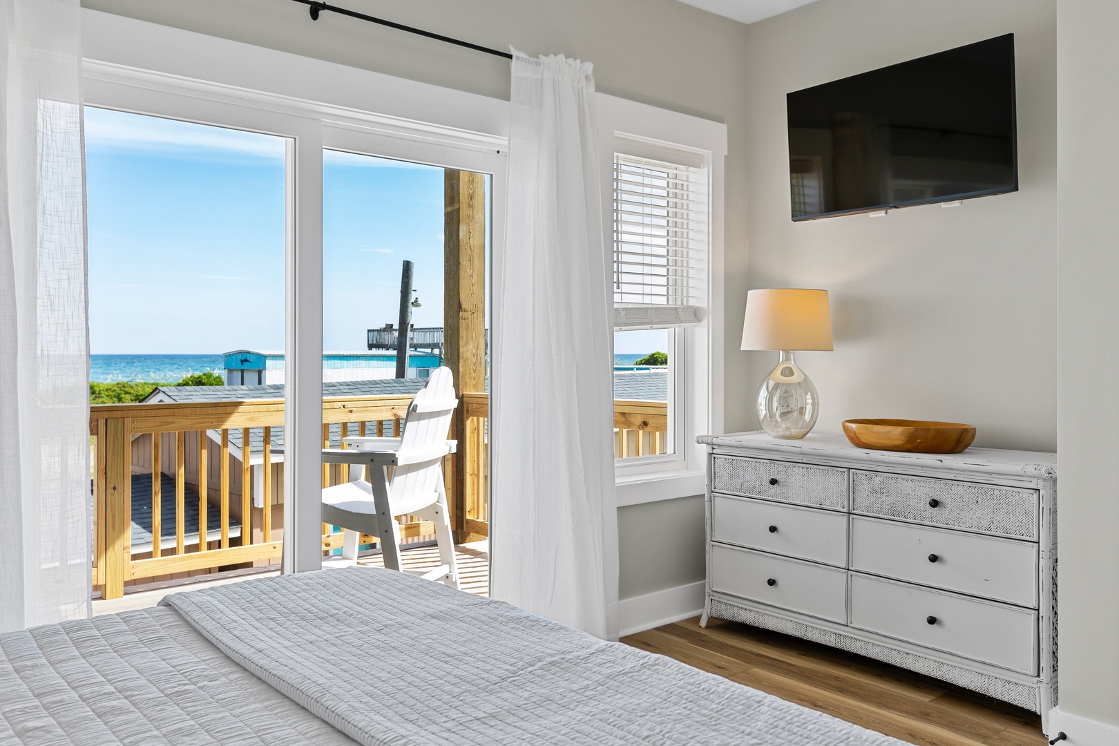 Bedroom 2 with a king-sized bed, Smart TV, and ocean view balcony access