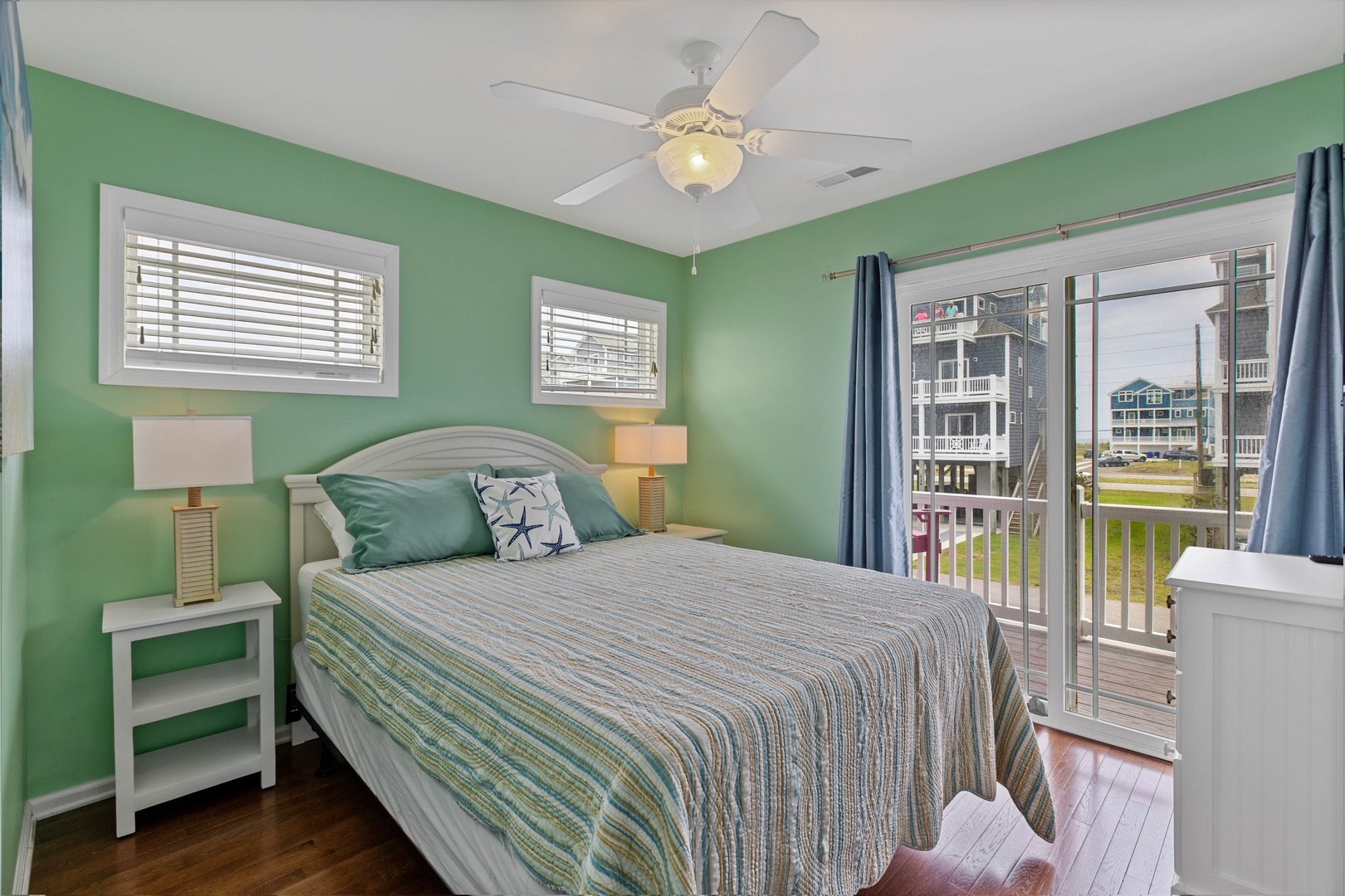 Bedroom 4 with a queen-sized bed, Smart TV, and first floor balcony access